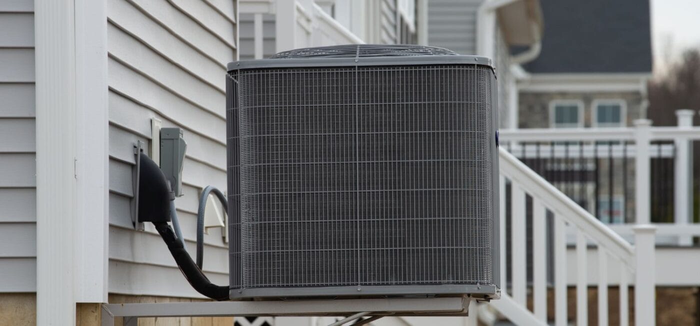 Outdoor air conditioning condenser unit installed beside a coastal home, illustrating a typical AC system used in Gulf Shores residential cooling.